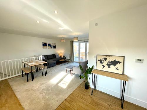 a living room with a couch and a table at New Modern 2 Bed with parking in BISHOPS STORTFORD, close to Stansted Airport! in Bishops Stortford