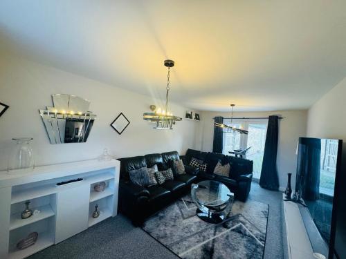 a living room with a couch and a table at Stunning 3-Bedroom in Alford Lincolnshire in Alford