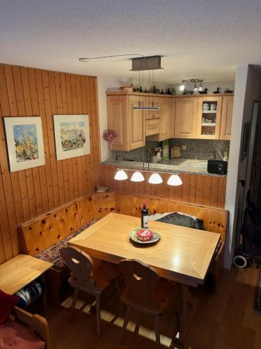 a kitchen with a wooden table and some chairs at Opal Nr 28 in Grächen