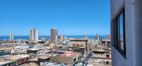 a view of a city from a building window at serrano 932 iquique departamento in Iquique