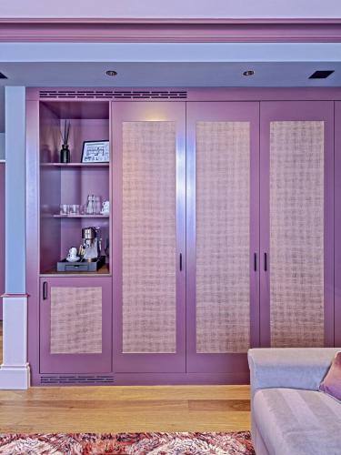 a living room with purple sliding doors at Hotel Mürren Palace in Mürren