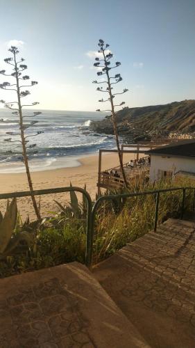 a stairway leading to a beach with the ocean at Casa Susana in Atouguia da Baleia