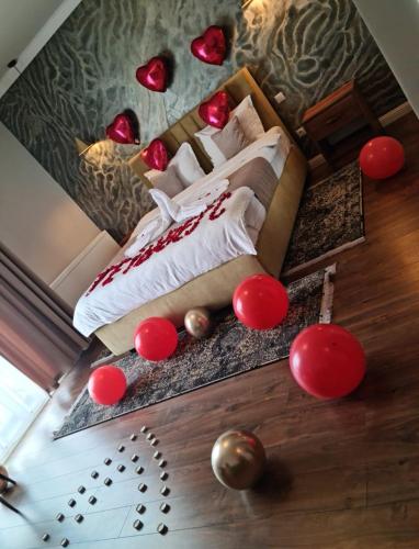 a bedroom with a bed with red decorations on the floor at Hotel Măgura Jina in Jina