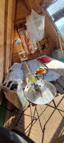 two glass tables in a room with a bed at La fatina Lodge in Barga