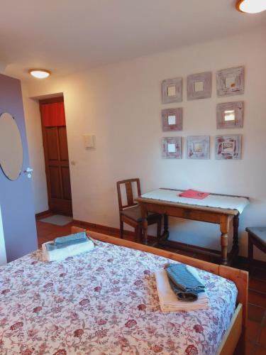a room with a bed and a table in it at Gorges du Verdon - Chambres d'Hotes des arches - Cadre magnifique, in Castellane