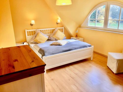 a bedroom with a bed and a large window at Straminke 4b Wohnung Dünentraum in Groß Kirr