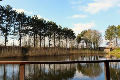 a body of water with trees in the background at The hill view in Evergem
