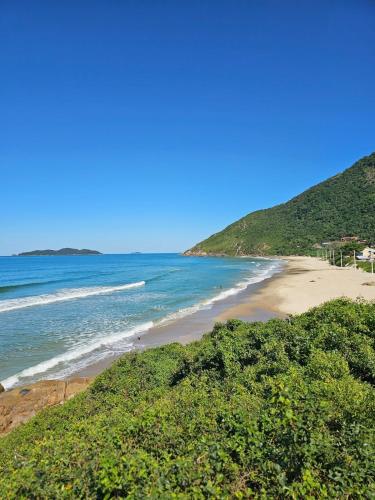 a view of a beach with the ocean at Nosso Mar in Florianópolis