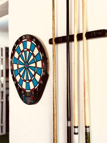 a dart board and some bats on a wall at La Maringa El Magnifico in Libreville