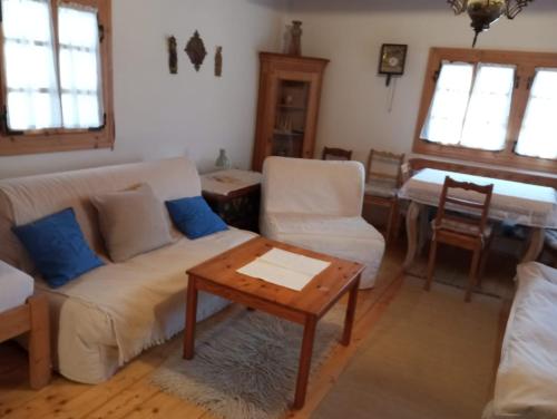 a living room with a couch and a table at Drevenica Traditional Cottage Old Centre in Zuberec