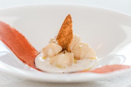 a plate of food with ice cream on a table at Castello Camemi in Vizzini