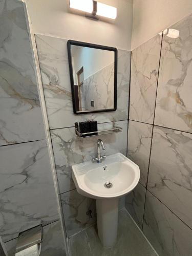 a bathroom with a sink and a mirror at Arcane viewfinder homestay in Gangtok
