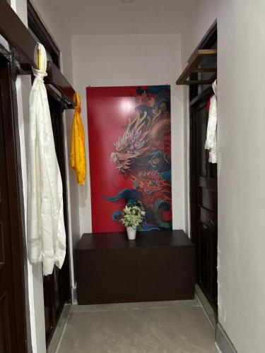 a hallway with a painting on the wall and a vase of flowers at Arcane viewfinder homestay in Gangtok