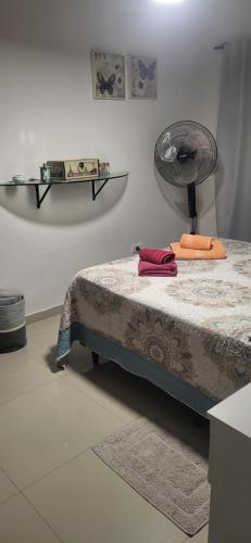 a room with a bed with a fan on it at Alquilo habitación hasta 2 personas en vivienda familiar in Estancia Vieja