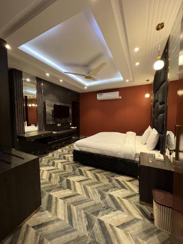 a hotel room with a bed and a bathroom at Courteous Hotel in Islamabad