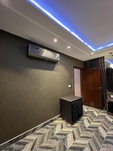 a hotel room with a television on a wall at Courteous Hotel in Islamabad