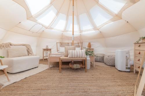 a room with a tent with a couch and a table at VILLA OSTUNI ONE mit Pool, Gästehaus & Glamping in Ostuni