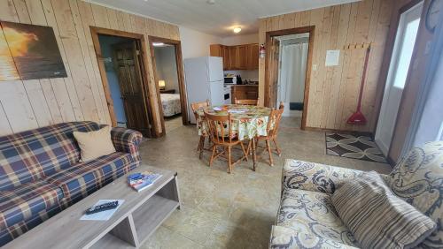 a living room with a couch and a table at Codroy Valley Cottage Country in Doyles
