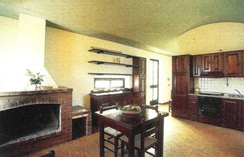 a large living room with a fireplace and a kitchen at Agriturismo Monte Sacro in Mattinata