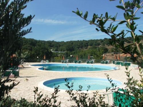 two swimming pools in the middle of a resort at Agriturismo Monte Sacro in Mattinata