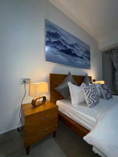 a bedroom with two beds and a nightstand with two lamps at Arcane viewfinder homestay in Gangtok