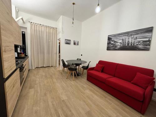 a living room with a red couch and a table at B&B Certosa Fiera in Milan