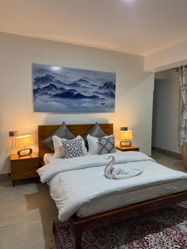 a bedroom with a large bed with two lamps at Arcane viewfinder homestay in Gangtok
