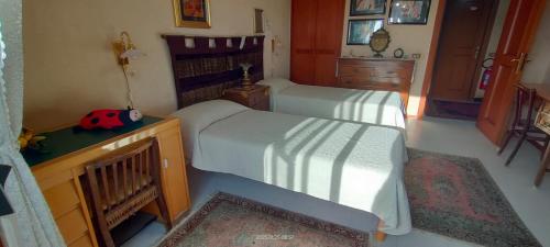 a bedroom with two twin beds and a dresser at MAMY PENTHOUSE in Palermo