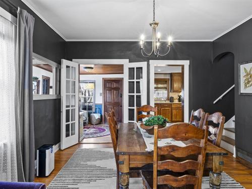 a dining room with a table and chairs and a kitchen at Red Wing - Peaceful Home Downtown in Red Wing