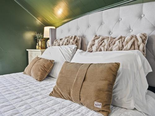 a bed with white sheets and pillows on it at Red Wing - Peaceful Home Downtown in Red Wing