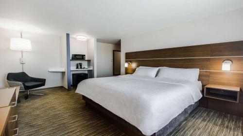 a hotel room with a large bed and a desk at Holiday Inn Express & Suites-Regina-South by IHG in Regina