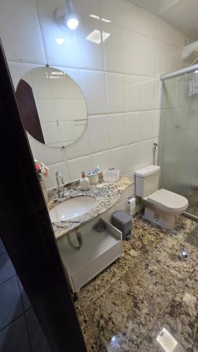 a bathroom with a sink and a toilet at Casa de Praia Em Jacaraípe in Serra