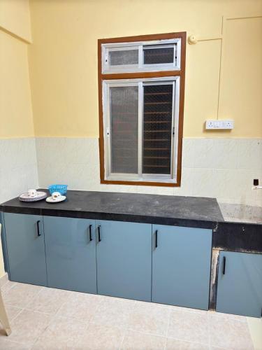 a counter in a room with a window at Shritik Homestay in Ratnagiri