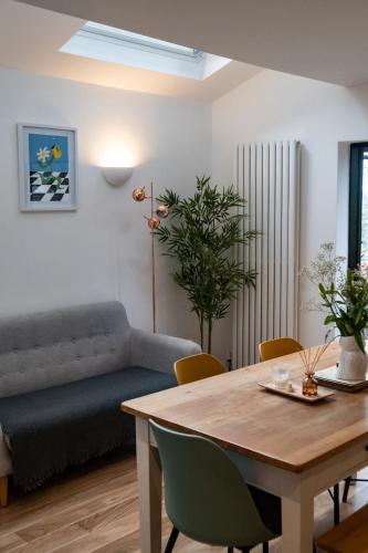 a living room with a table and a couch at Stylish Brighton Haven, Sleeps 1 to 7, free parking in Brighton & Hove