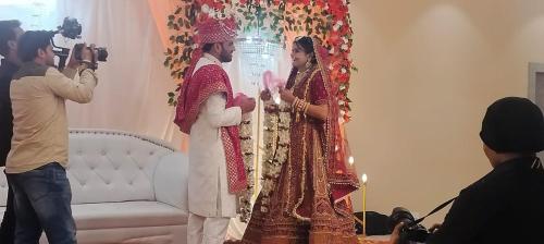 a bride and groom standing in front of a altar at SB INTERNATIONAL Hotel & Banquet in Dhanbād
