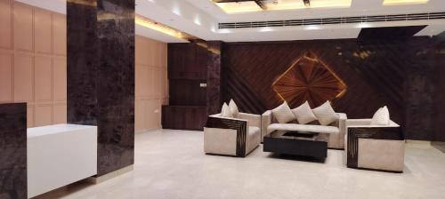a room with a couch and chairs in it at SB INTERNATIONAL Hotel & Banquet in Dhanbād