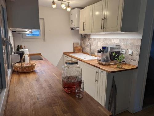 a kitchen with a wooden counter top with a jar on it at Modern bungalow with direct lake access and fireplace in Zossen