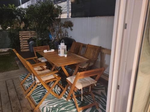 a wooden table and chairs on a patio at juvignac nono in Juvignac
