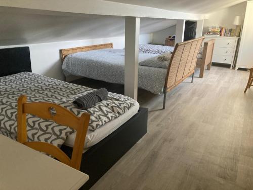 a bedroom with two beds and a table and chairs at Maison avec vue sur Paris et la Tour Eiffel in Champigny-sur-Marne