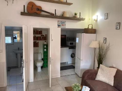 a living room with a couch and a refrigerator at Maison avec vue sur Paris et la Tour Eiffel in Champigny-sur-Marne
