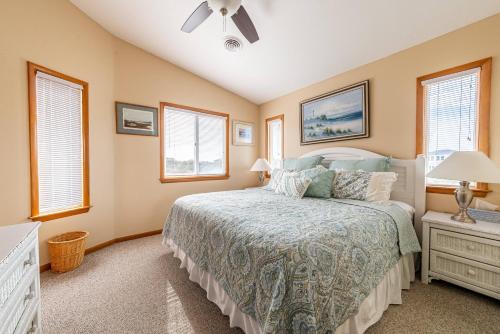 a bedroom with a bed and a ceiling fan at Duck R Way in Duck