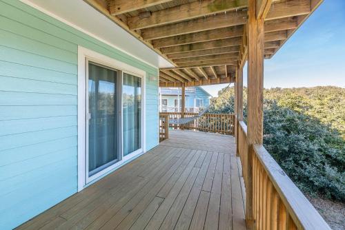 a porch of a house with a wooden deck at Duck R Way in Duck