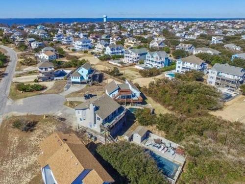 an aerial view of a neighborhood with houses and the ocean at Duck R Way in Duck