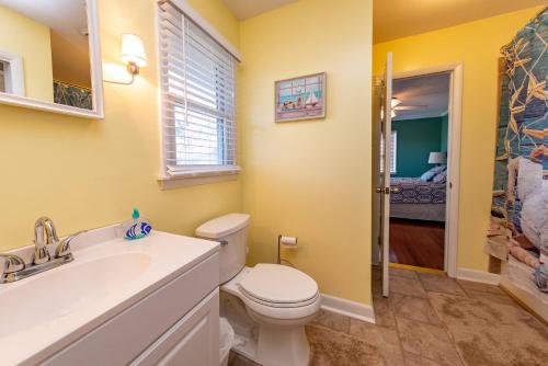 a bathroom with a toilet and a sink at Landing Pad in Kill Devil Hills
