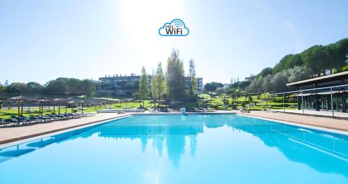a large swimming pool in a resort with blue water at Apartment Belleview in Lagos