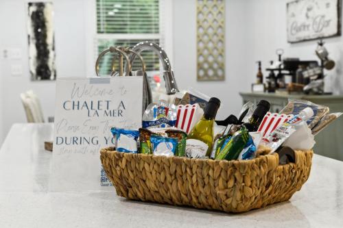 a basket filled with alcohol on top of a counter at LaMaison Cotiere Coastal Retreat w Elegance in Bay Saint Louis