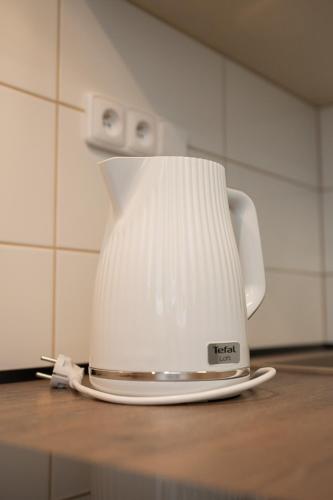 a white coffee maker sitting on top of a counter at Apartmán Radvanička in Radvanice