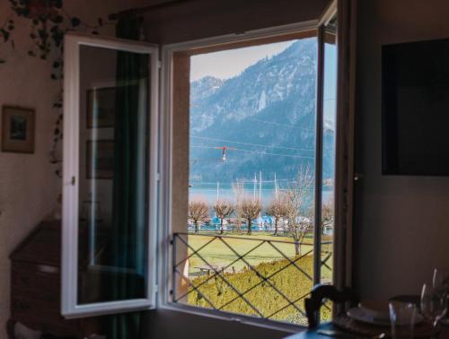 a window with a view of a mountain at La Belle Vue Studio - Lakeview, Pool, Free Parking in Därligen