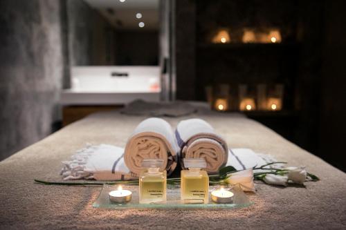 a spa setting with towels and candles on a bed at D - Resort Ayvalık in Ayvalık