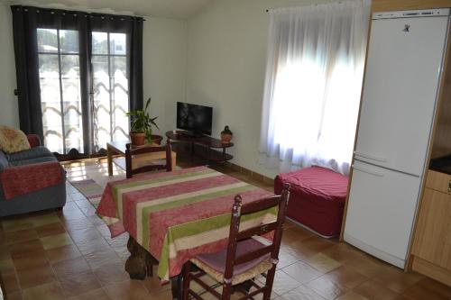 a living room with a table and a couch at Hotel Restaurant El Bosc in Banyeres del Penedes
